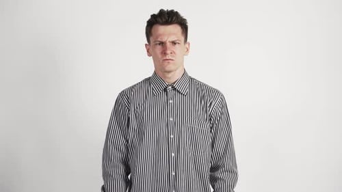 A Young Man of Caucasian Appearance and Angry Swears Directly To the Camera Waving His Hands.