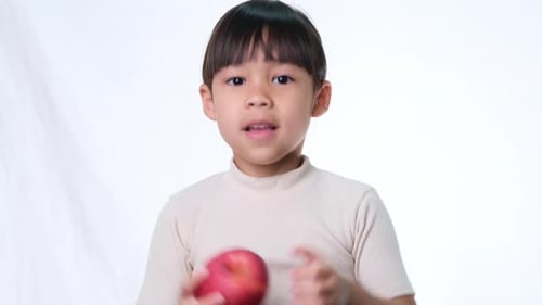 Young Girl Eating Red Apple, Thumbs Up