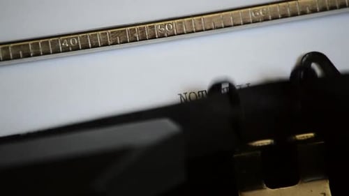 Typing 'Not Guilty' on Antique Typewriter Close Up