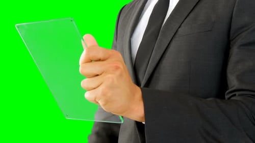 Man Interacts with Transparent Tablet on Green Screen