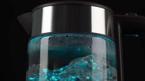 Electric Kettle with Boiling Water and Cyan Light