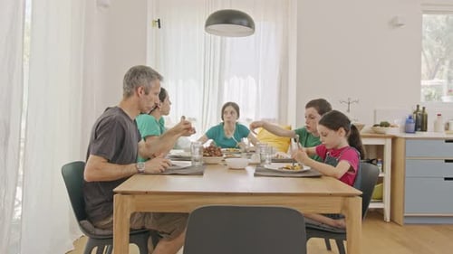 Family Eating Lunch Together at Bright Dining Table
