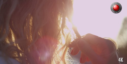 Woman Twisting Hair During Sunset