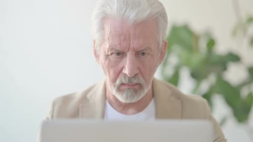 Close Up of Old Man Using Laptop in Office