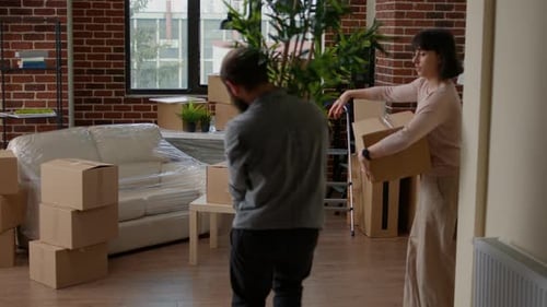Couple Moving Into New Apartment With Boxes
