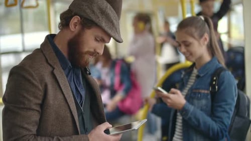 Stylish Man in Looking down at Tablet in Trolleybus