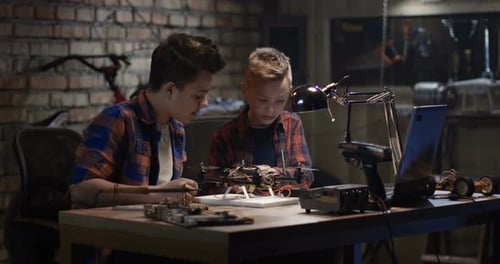 Two Boys Repairing a Drone