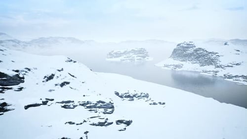 Winter Aerial View of Snowy Mountains and Lake