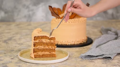 Layered Caramel Cake Slice Being Cut