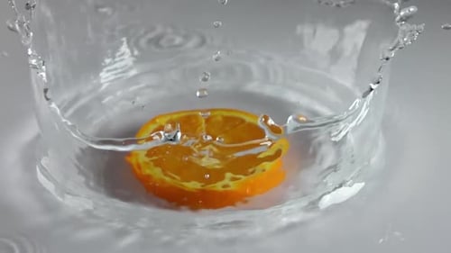 Slice of Orange Falls Into the Water