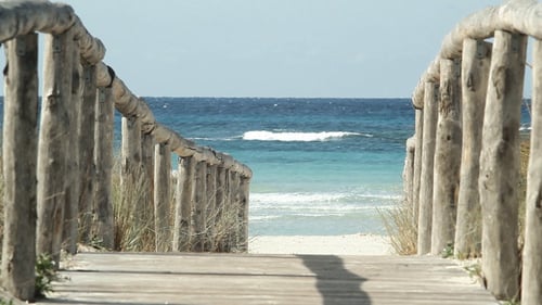 Waves Break On Shore And Wooden Path To Beach