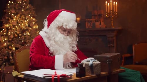 Santa Claus Writing at Desk on Christmas Eve