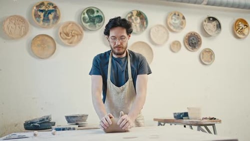 Man Potter Kneading Clay Before Molding at Pottery Workshop Creative Skills Concept