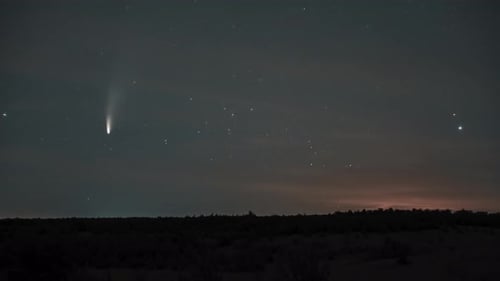 Comet Shining Brightly in Starry Night Sky