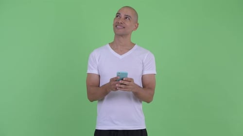 Man Using Smartphone Against a Green Screen