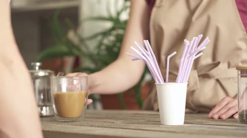 Coffee Exchange at Cafe Counter with Natural Lighting