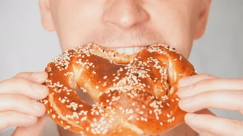 Close Up Face Fair Man Eating Eats Crisp Biscuit Flavored with Salt