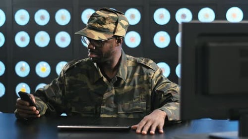 Man in Camouflage Shirt Talking on Phone