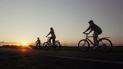 Family Bike Ride at Sunset on Rural Road