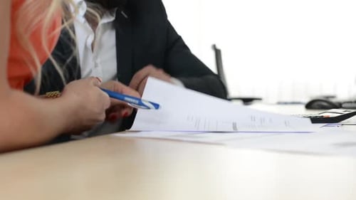 Couple (Man and Woman) Sign a Contract in the Office - Closeup Hands