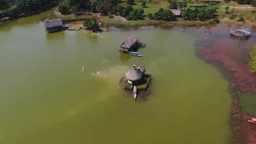 Tropical Thatched Roof Bungalows on Lake Aerial View