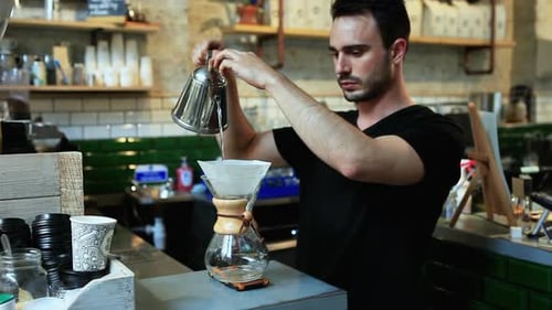 Young Adult Barista Making Pour-Over Coffee at Cafe