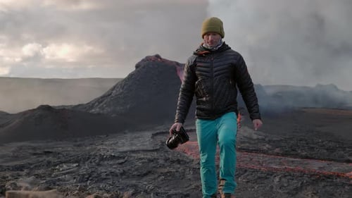Photographer Walking In Front Of Lava Flow From Erupting Fagradalsfjall Volcano