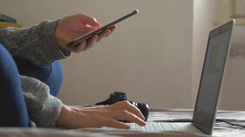 Hands with smart phone and laptop