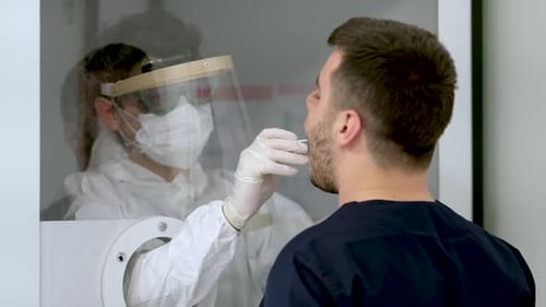 Man Getting Swab Test in Clinical Setting