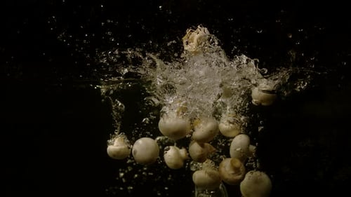 Mushrooms falling in water, Ultra Slow Motion