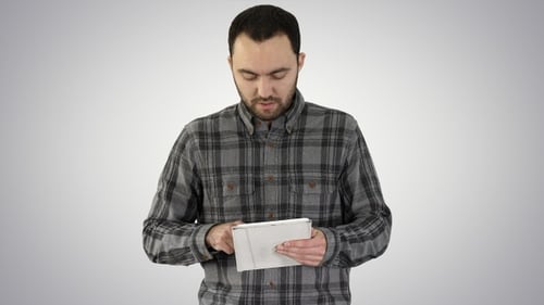 Man Taps On Tablet Device