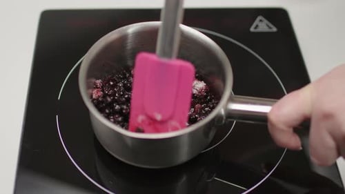 Making Berry Sauce in a Pan on Cooktop