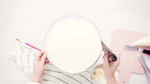 Time lapse. Applying food glitter to a white cake to make a unicorn cake.