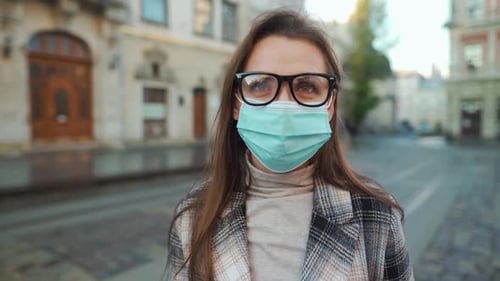 Woman with Medical Mask Standing on City Street