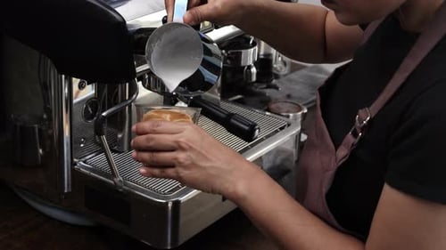 Adult Pouring Milk Into Coffee For Latte Art