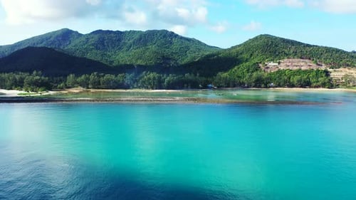 Daytime flying island view of a white paradise beach and aqua turquoise water background in colorful