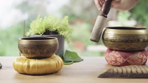 Meditation Bowls Crystals Feathers on Wooden Table