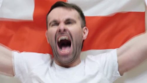 Man Yelling with Enthusiasm Holding a Flag