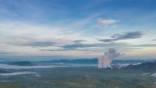 Coal-fired power plants that steam into the atmosphere from the chimney.