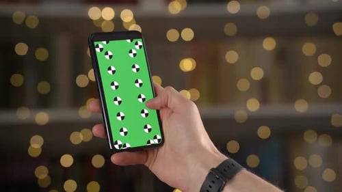 Man Swipes Up and Down Then Taps on Smartphone Display with Tracking Markers in Closeup