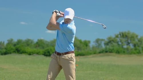 Man Plays Golf on the Green Course