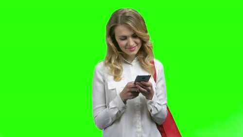 Smiling Woman Using Phone on Green Screen