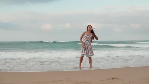 Girl Dances Barefoot Along Sandy Beach