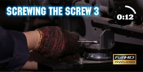 Hands tighten bolt on machinery using wrench