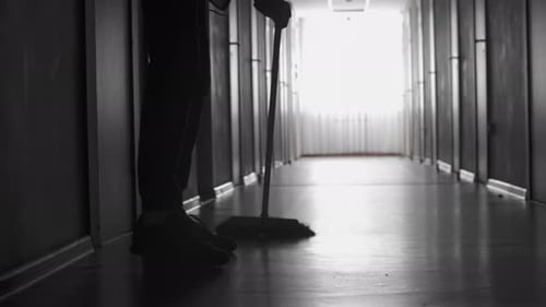 Unrecognizable Janitor Sweeping Floor