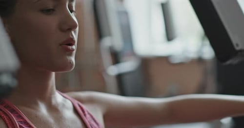 Attractive Fit Middle Age Woman Athlete Doing Exercises on Pectoral Muscles in Simulator. Gym