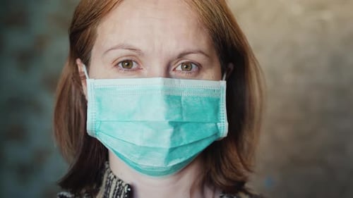 Portrait of a Young Woman in a Medical Mask. The Quarantine Concept