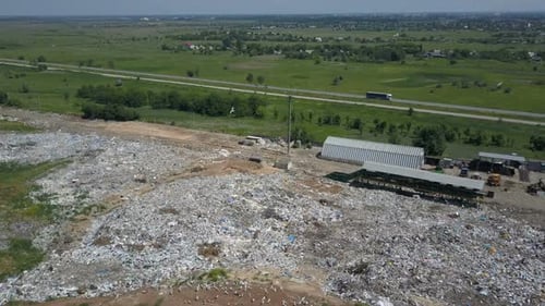 Aerial View of City Garbage Dump. Gypsy Family with Children Separates Trash To Gain Some Money