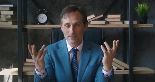 Man in Business Suit Talking in Office Setting
