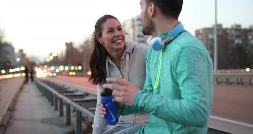 Athletic Couple Relaxing After Jogging in the City
